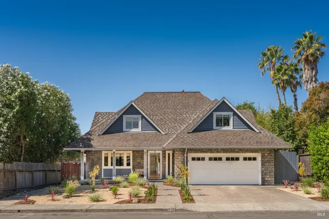 a front view of a house with a garden