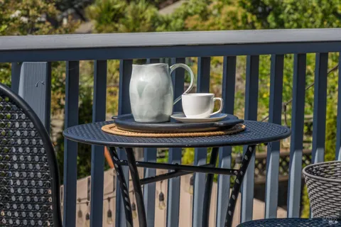 a view of a balcony furniture and floor to ceiling window