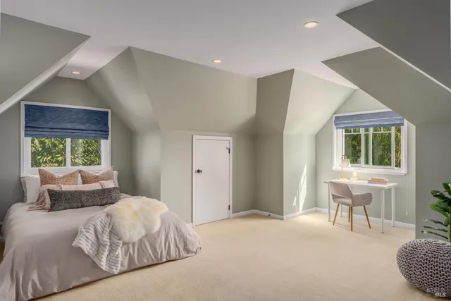 a bedroom with a large bed and a window