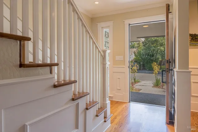 a view of a hallway with wooden floor and entryway