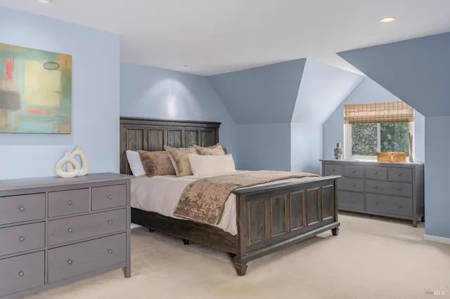 a bed sitting in a bedroom next to a window