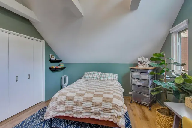 a bedroom with bed and a window