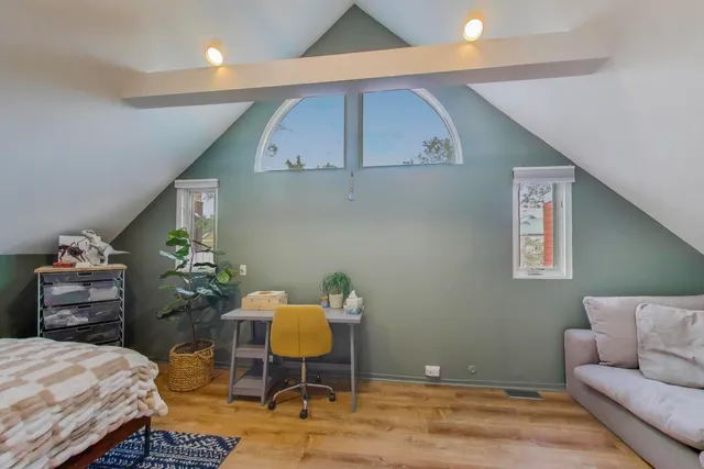 a living room with furniture and flowers