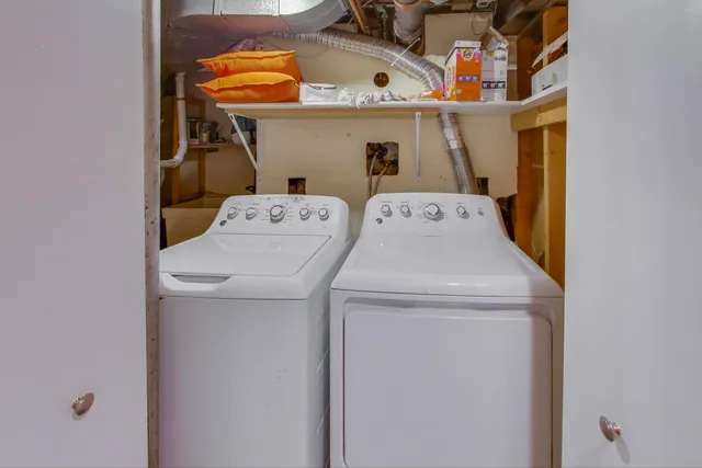 a view of a patio with table and chairs potted plants and large tree