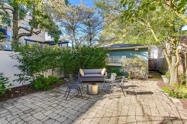 a view of backyard with outdoor seating and trees