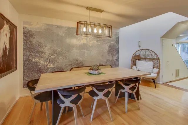 a view of a dining room with furniture and wooden floor