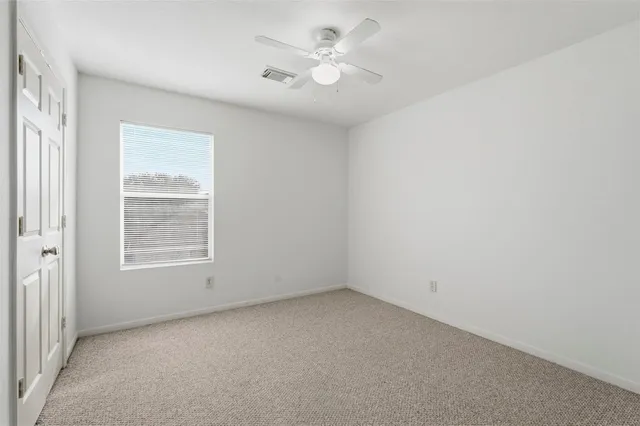 an empty room with a ceiling fan