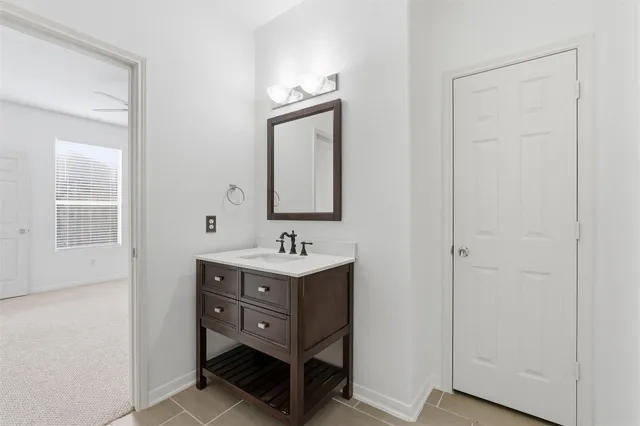 an empty room with a ceiling fan and a chandelier fan