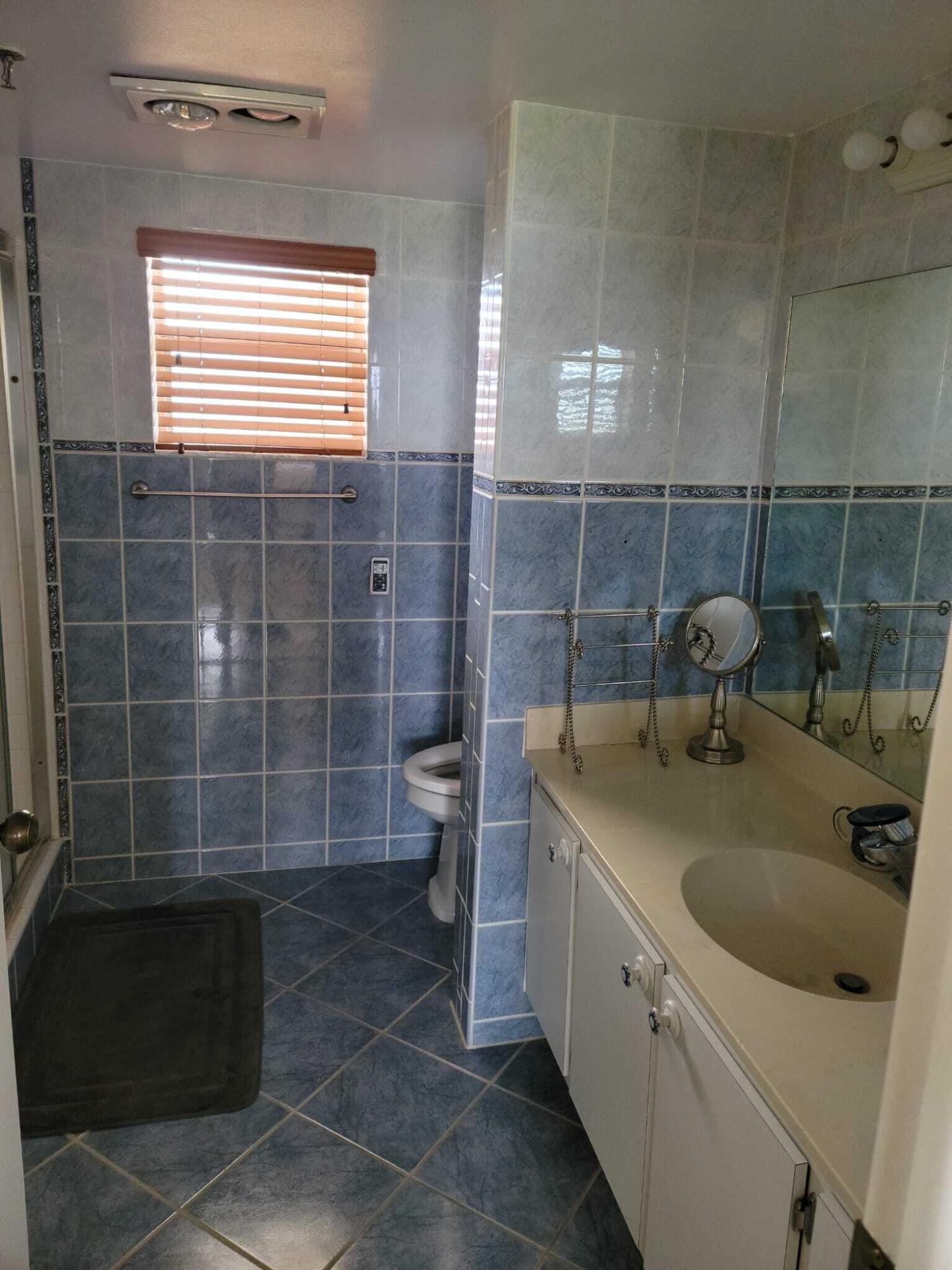 3465 Via Poinciana, Unit 806 Lake Worth, FL 33467 - Photo 12 of 22 a bathroom with a sink toilet and shower