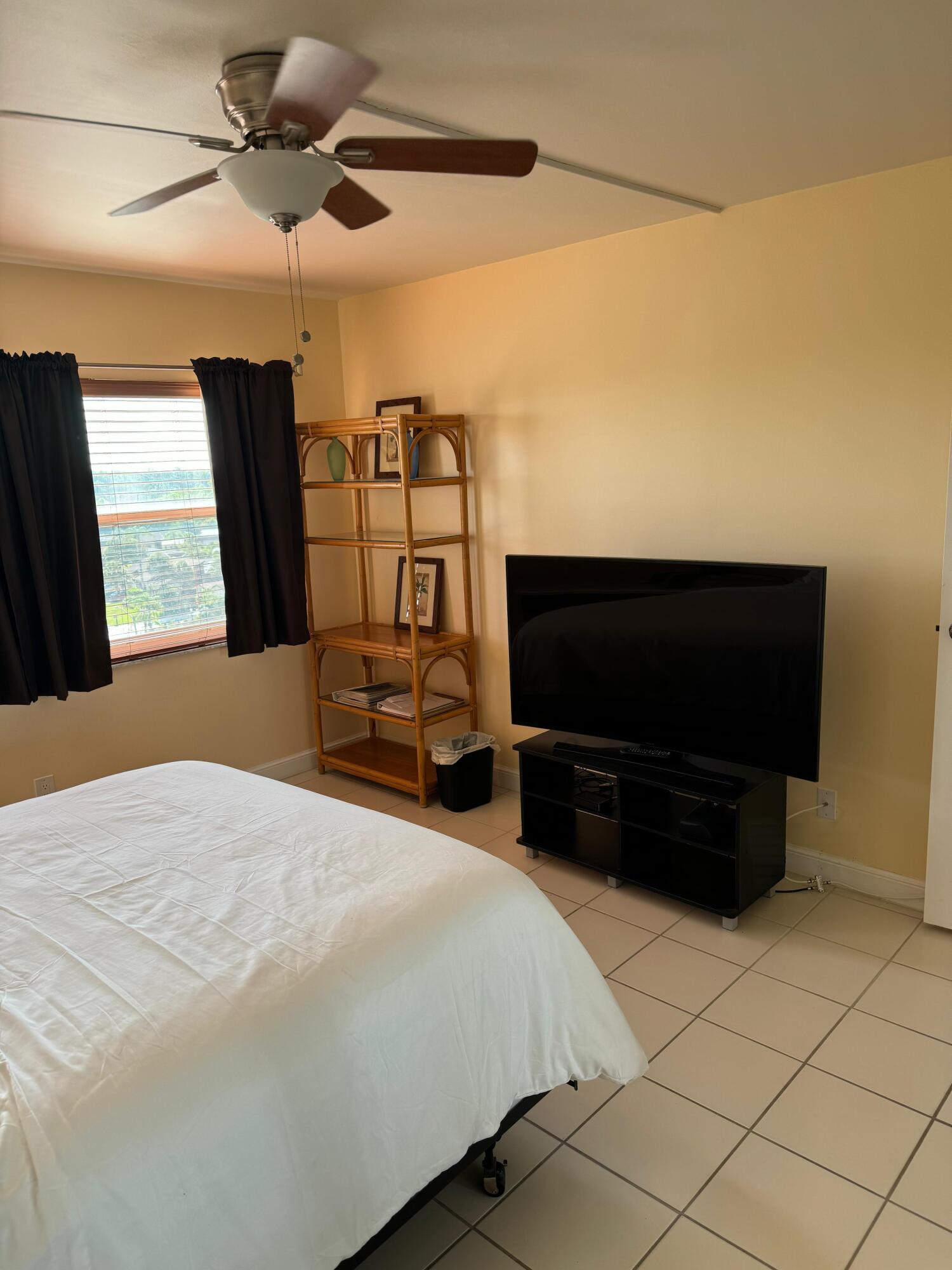 3465 Via Poinciana, Unit 806 Lake Worth, FL 33467 - Photo 15 of 22 a bedroom with a bed and a flat screen tv