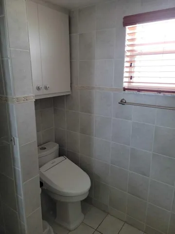 a bathroom with a toilet and a window