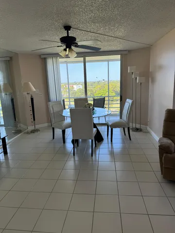 a view of a dining room with furniture and a window