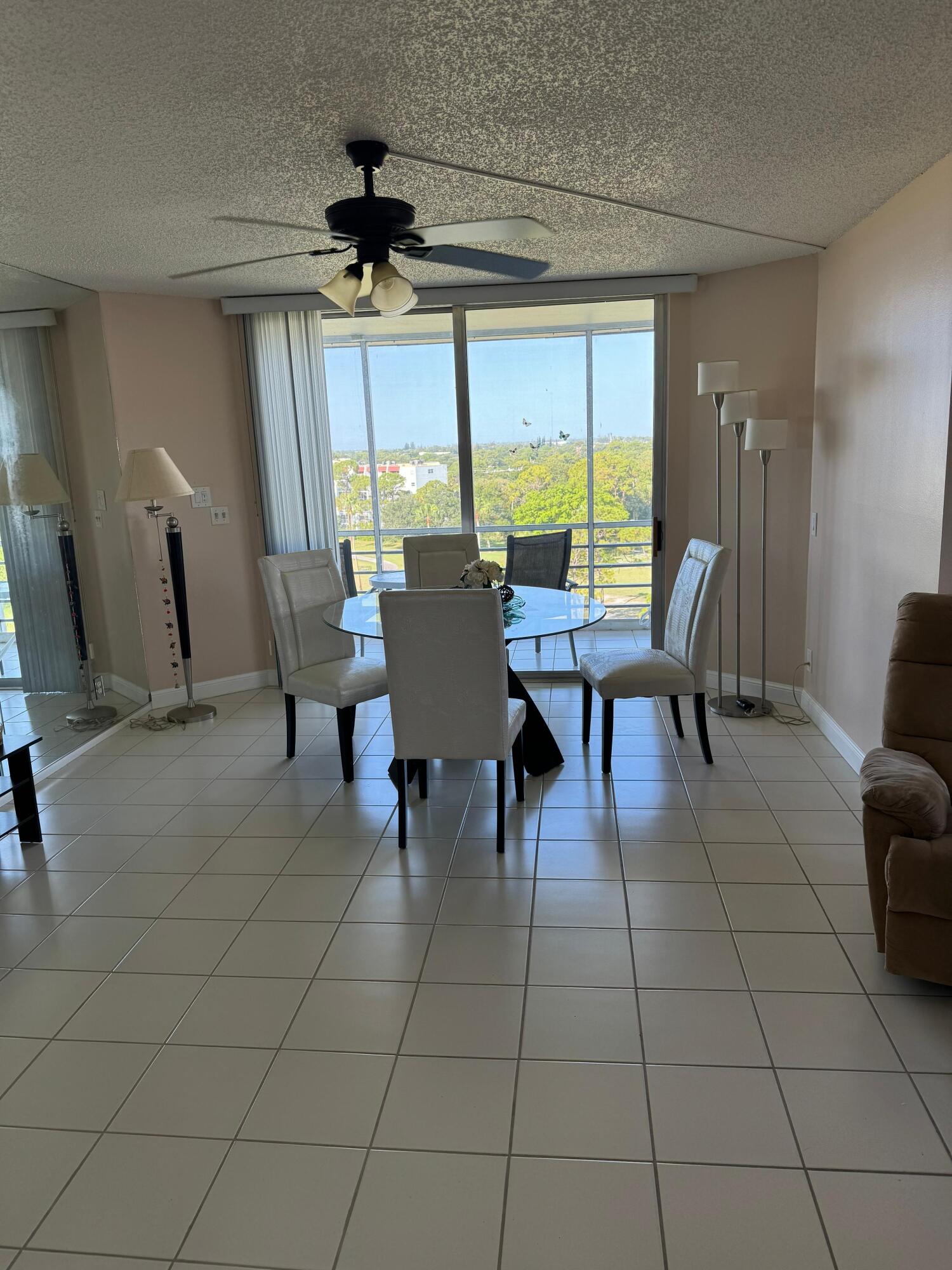 3465 Via Poinciana, Unit 806 Lake Worth, FL 33467 - Photo 3 of 22 a view of a dining room with furniture and a window