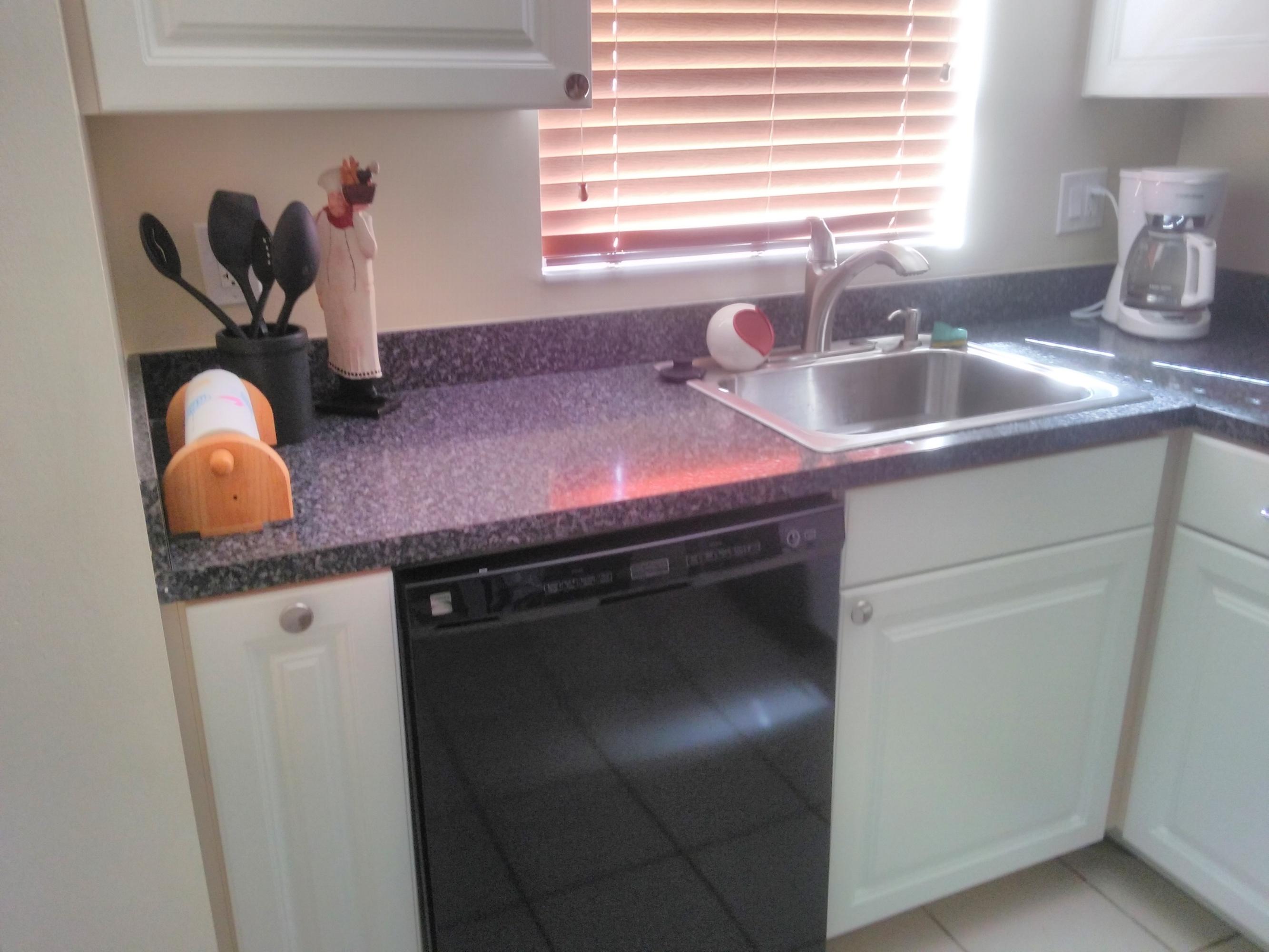3465 Via Poinciana, Unit 806 Lake Worth, FL 33467 - Photo 7 of 22 a kitchen with a sink and a window