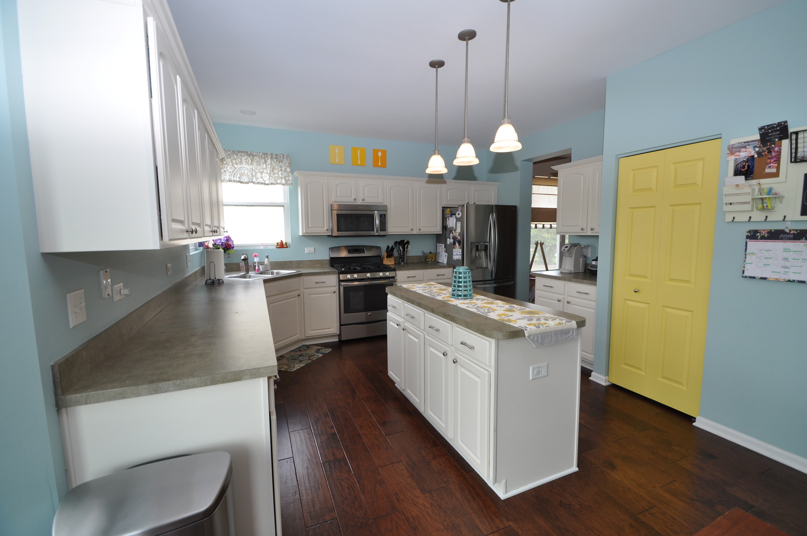 25056 Spring Street Manhattan, IL 60442 - Photo 8 of 24 a kitchen with a sink stainless steel appliances a window and dining table