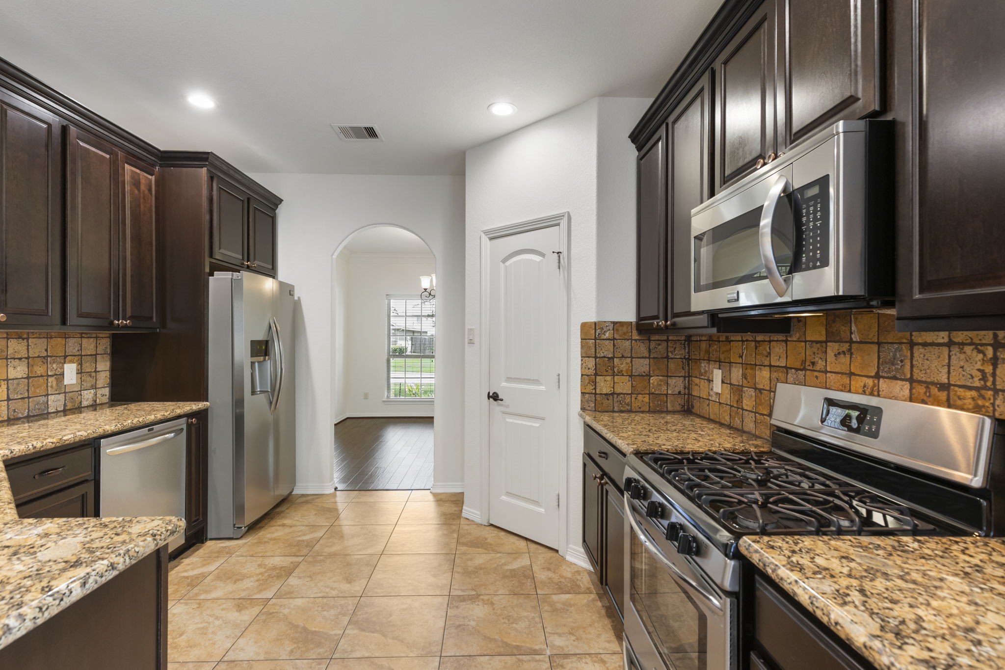 23911 Augusta Falls Lane Spring, TX 77389 - Photo 8 of 40 a kitchen with stainless steel appliances granite countertop a stove refrigerator and cabinets