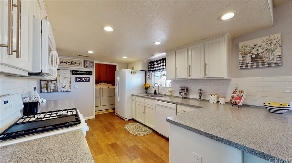 14510 Gayhead Road Apple Valley, CA 92307 - Photo 1 of 1 a kitchen with sink cabinets and stove top oven