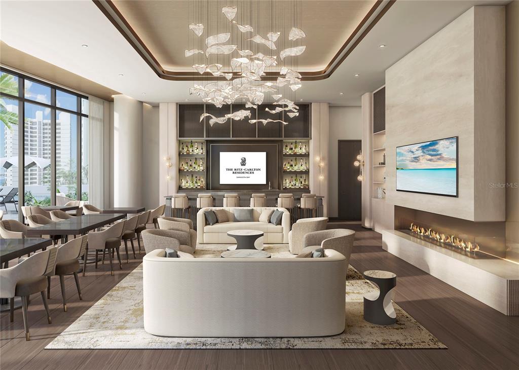 555 Quay Common, Unit 1703 Sarasota, FL 34236 - Photo 3 of 8 a living room with couches a large dining table and a chandelier