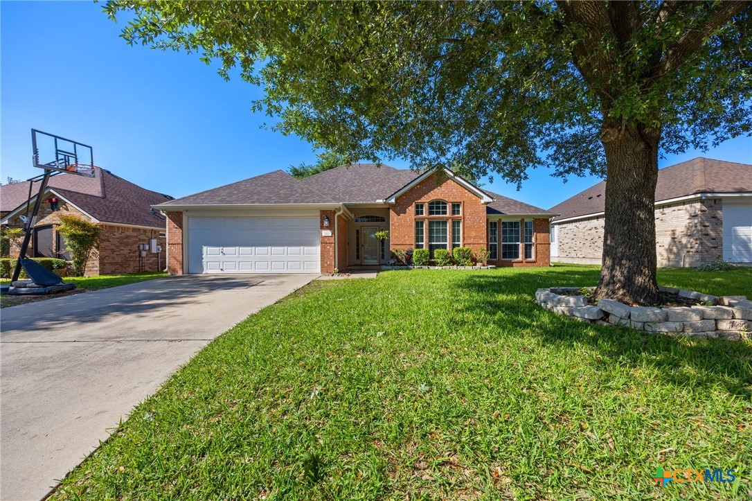 910 Neuberry Cliffe Temple, TX 76502 - Photo 3 of 32 a front view of a house with a garden and trees