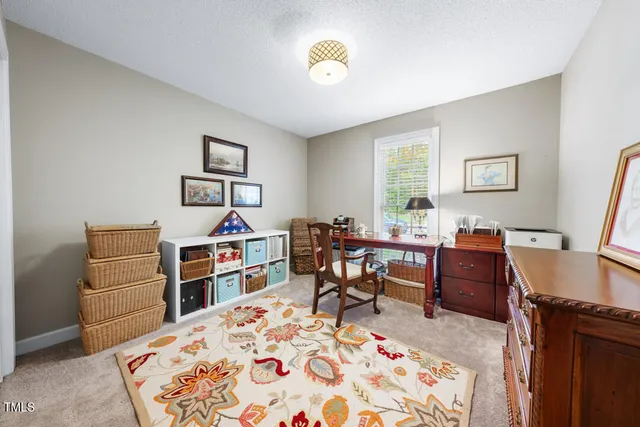 a view of a workspace with furniture and a window