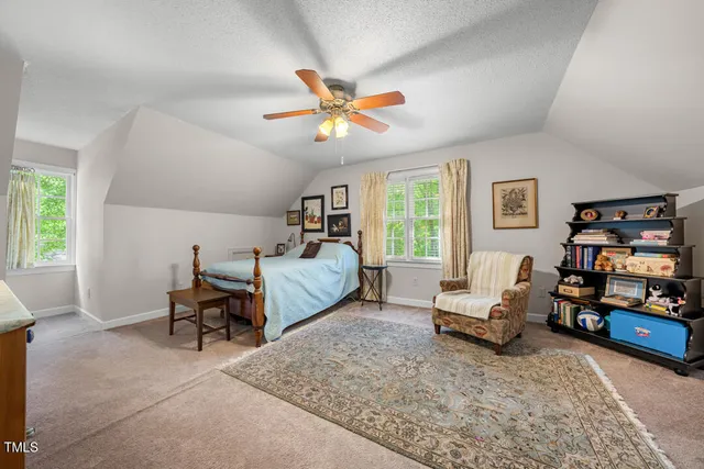 a bedroom with furniture and a window