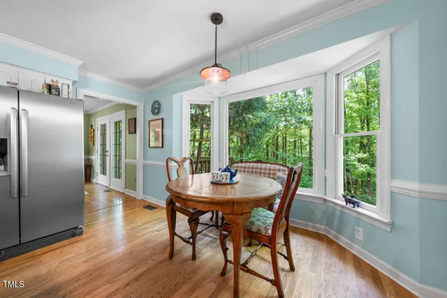 a dining room with furniture window wooden floor