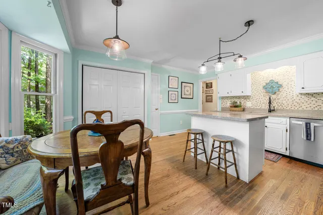 a view of a dining room with furniture window and wooden floor