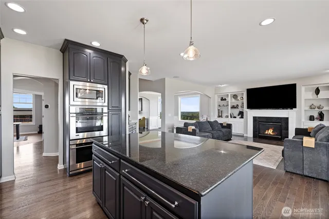 a kitchen with stove and refrigerator