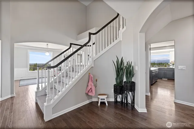 a view of entryway and hall with wooden floor