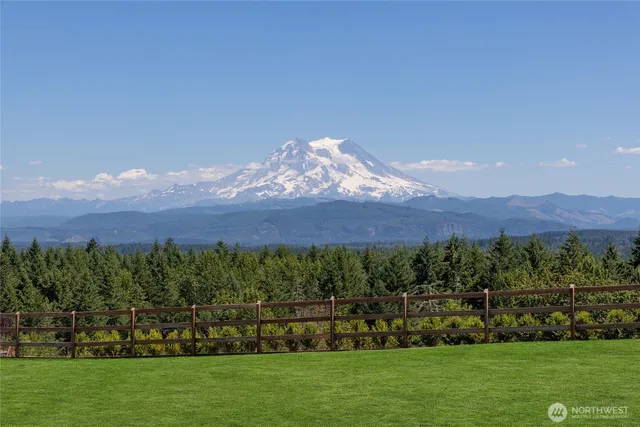 a view of a lush green hillside and a houses