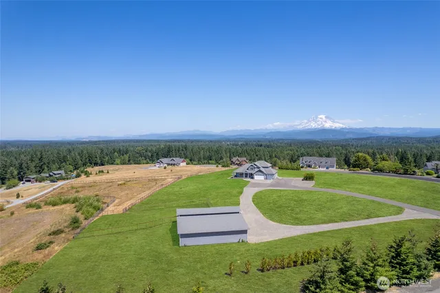 an aerial view of a house with yard and outdoor seating