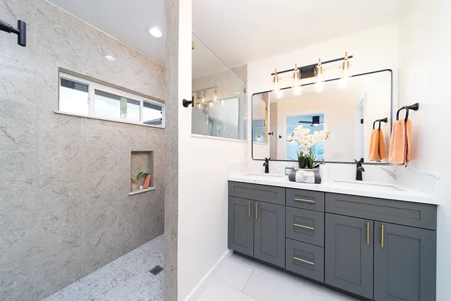 a bathroom with a double vanity sink a mirror and shower