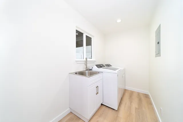 a utility room with a sink washer and dryer