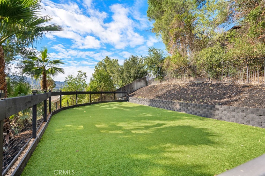 23229 8th Street Newhall, CA 91321 - Photo 14 of 52 a view of a garden with swimming pool