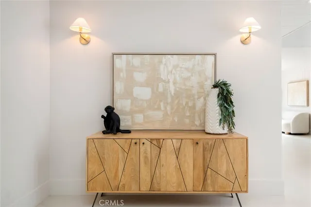 a living room with furniture a fireplace and a large window