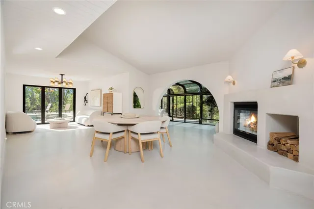 a living room with furniture a rug and a window