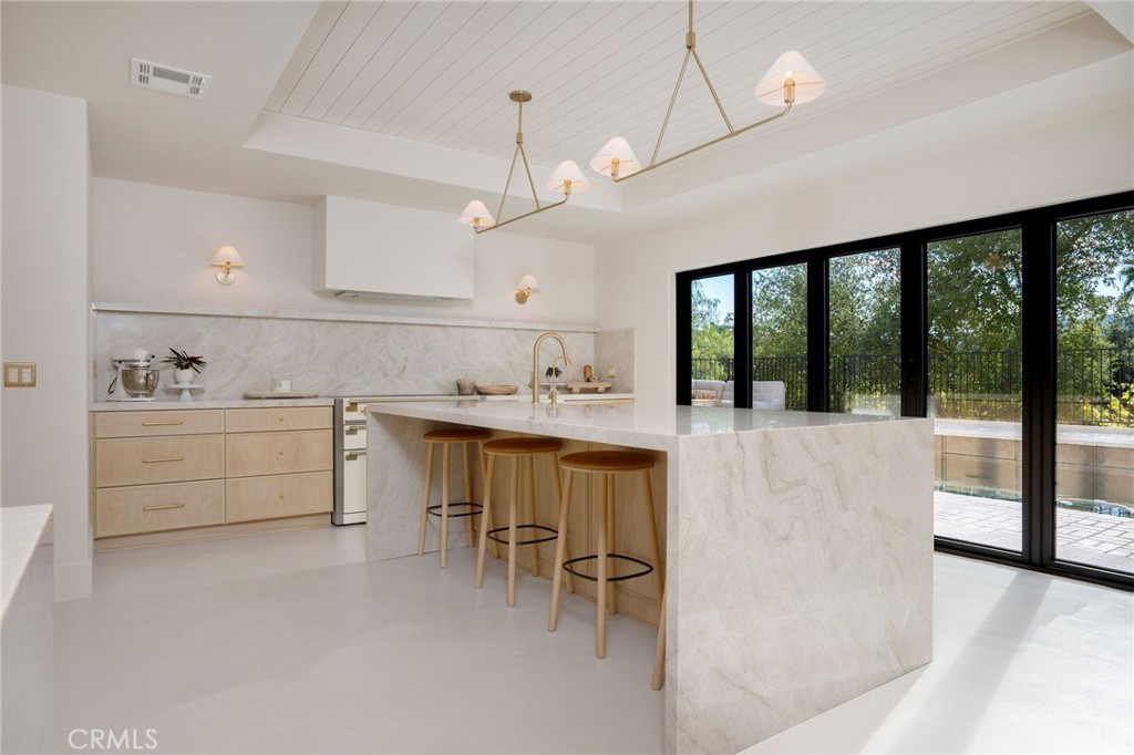 23229 8th Street Newhall, CA 91321 - Photo 23 of 52 a kitchen with a sink window and cabinets