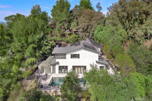 an aerial view of a house with a yard