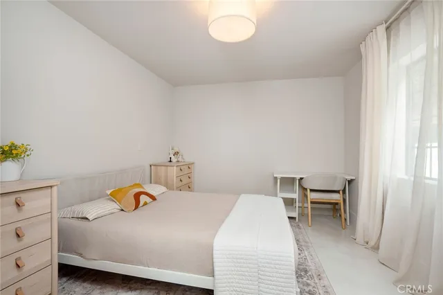 a bedroom with a bed and chandelier