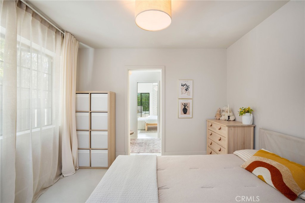 23229 8th Street Newhall, CA 91321 - Photo 33 of 52 a bedroom with a bed and chandelier