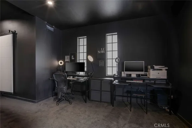 a spacious bedroom with a bed and a flat screen television