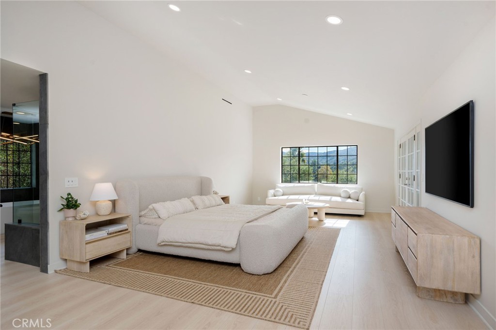 23229 8th Street Newhall, CA 91321 - Photo 37 of 52 a spacious bedroom with a bed and a flat screen television
