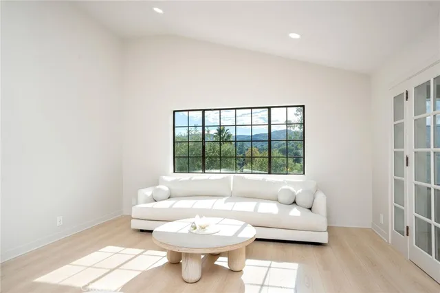 a spacious bathroom with a double vanity sink a large mirror and a bathtub