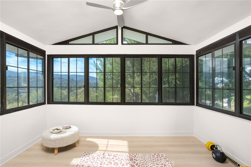 23229 8th Street Newhall, CA 91321 - Photo 40 of 52 a living room with a bed and a large window