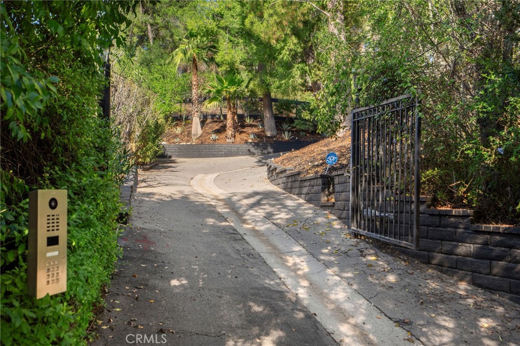 23229 8th Street Newhall, CA 91321 - Photo 4 of 52 a view of a pathway with a wrought fence