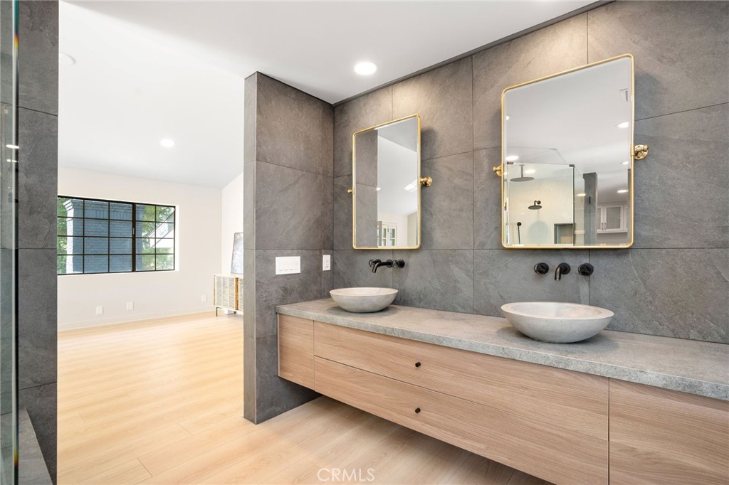 23229 8th Street Newhall, CA 91321 - Photo 43 of 52 a bathroom with a granite countertop double vanity sink and mirror