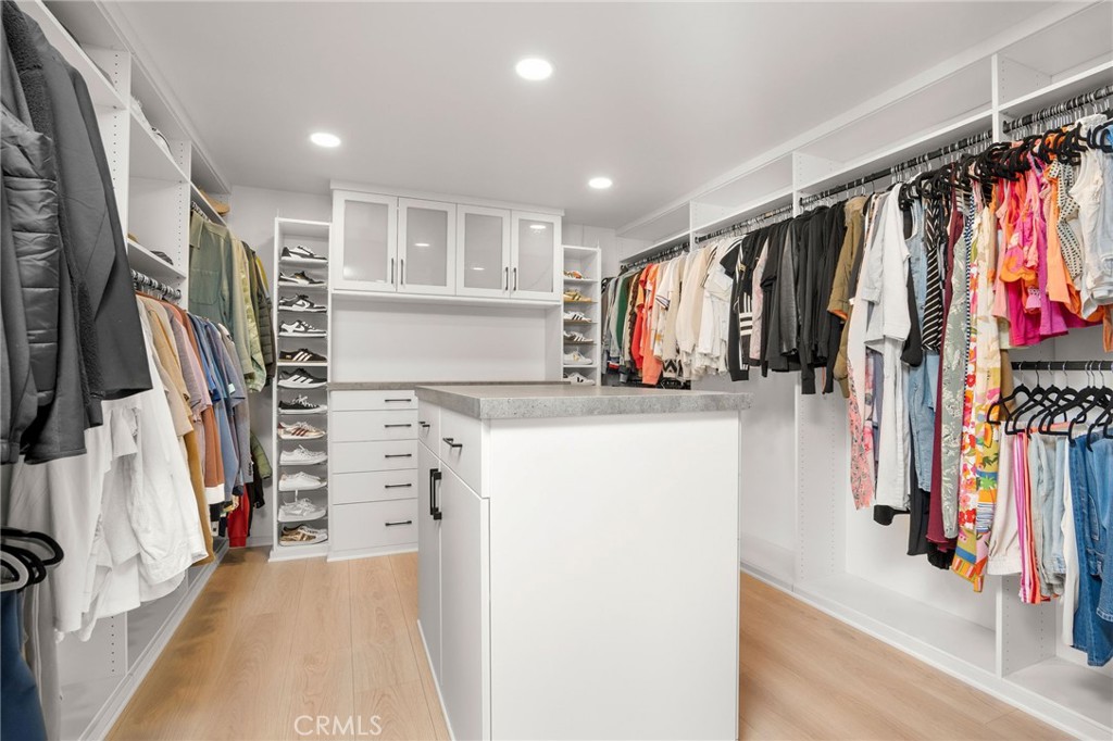 23229 8th Street Newhall, CA 91321 - Photo 45 of 52 a view of walk in closet with clothes and shoes