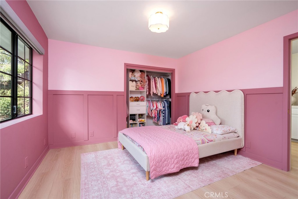 23229 8th Street Newhall, CA 91321 - Photo 46 of 52 a bedroom with pink bed and a window