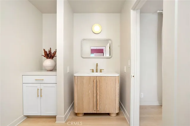 a bedroom with a bed and a view of living room