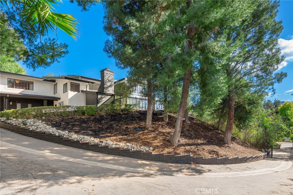 23229 8th Street Newhall, CA 91321 - Photo 5 of 52 a front view of a house with garden